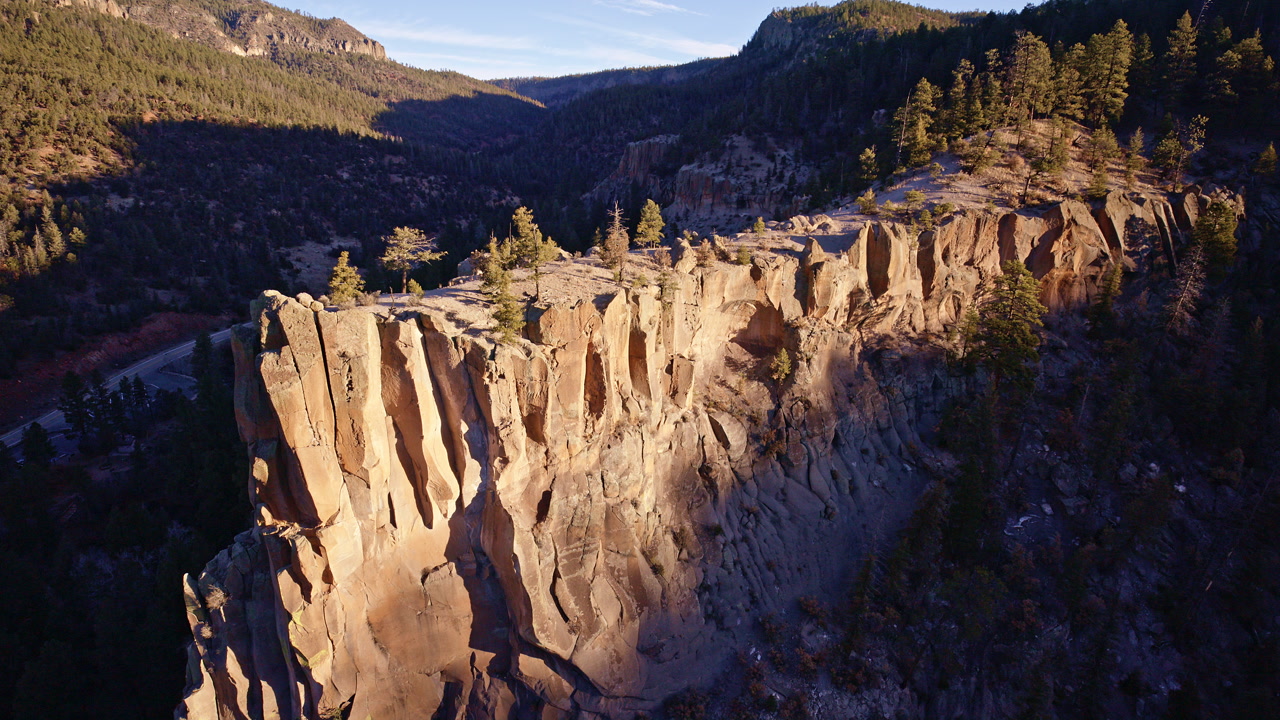 Cinematic aerial shot of desert canyon cliffs near Los Alamos NM