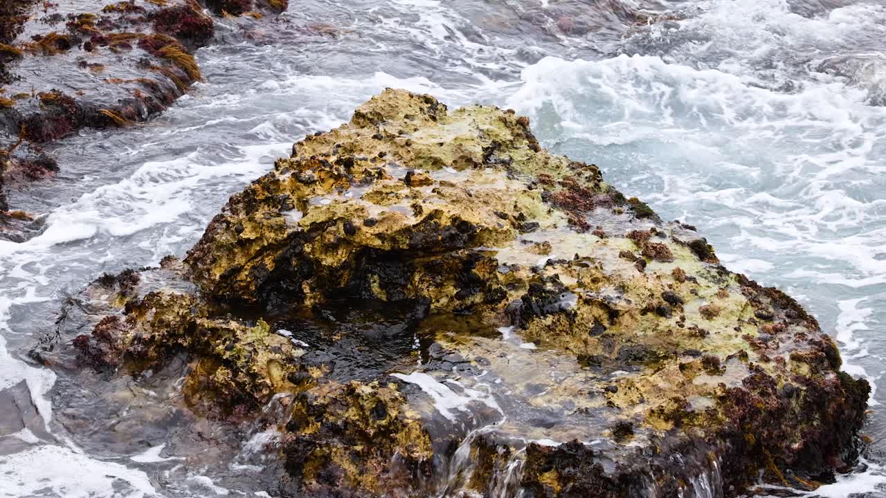 Dynamic ocean waves crash against rugged rocks, showcasing nature's power and beauty along Australia's Great Ocean Road