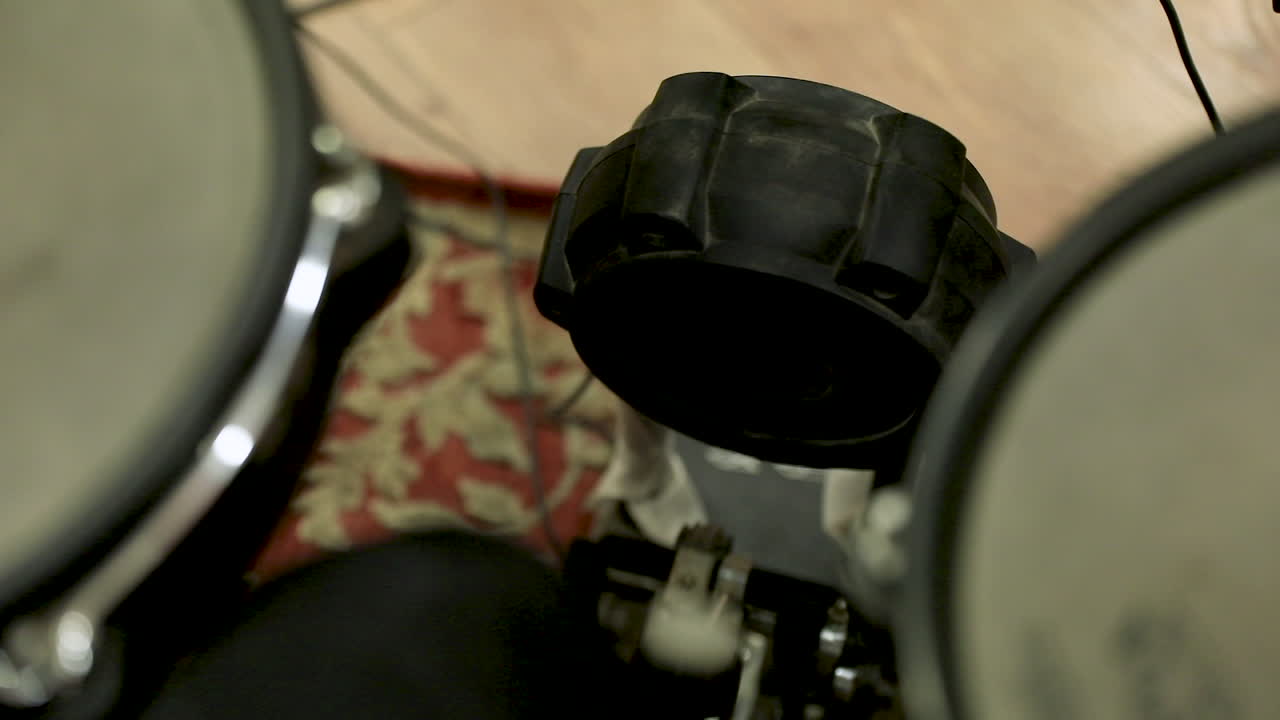 A man playing the drums in the studio - close up