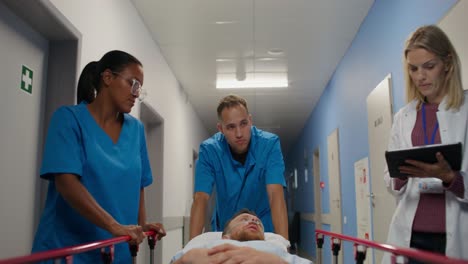 hospital staff moving patient on stretcher