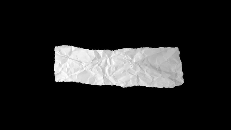 Torn piece of white paper on black background