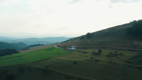 Aerial-shot-approaching-a-lone-church-on-the-side-of-Javor-mountain-in-western-Serbia