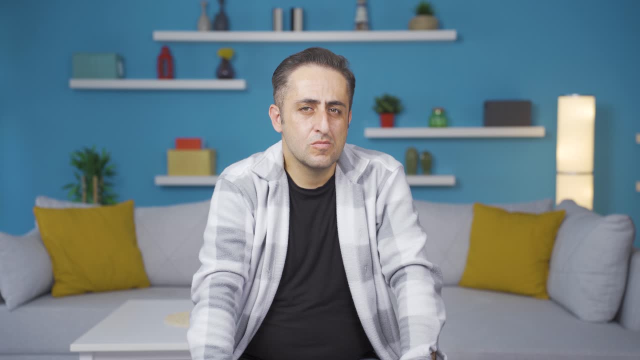 Man looking depressed at camera.