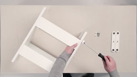 assembling a white wooden table