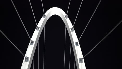 abstract arch city bridge architecture with cables and metal frame at night