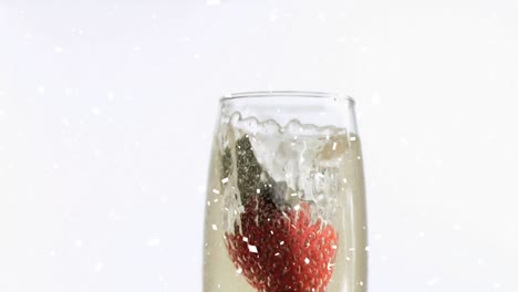Animation-of-strawberry-falling-into-glass-of-champagne,-with-confetti-falling-on-white-background
