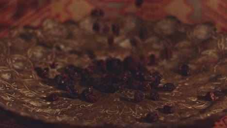 dried raisins falling into a serving dish