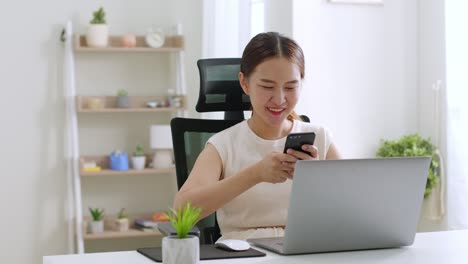 young asian beautiful woman using smart phone for business working, online shopping, transfer money, financial, internet banking at home office