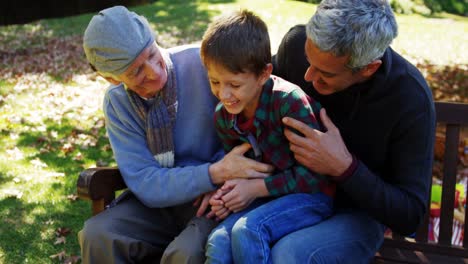 grandfather-father-and-son-laughing-outdoors