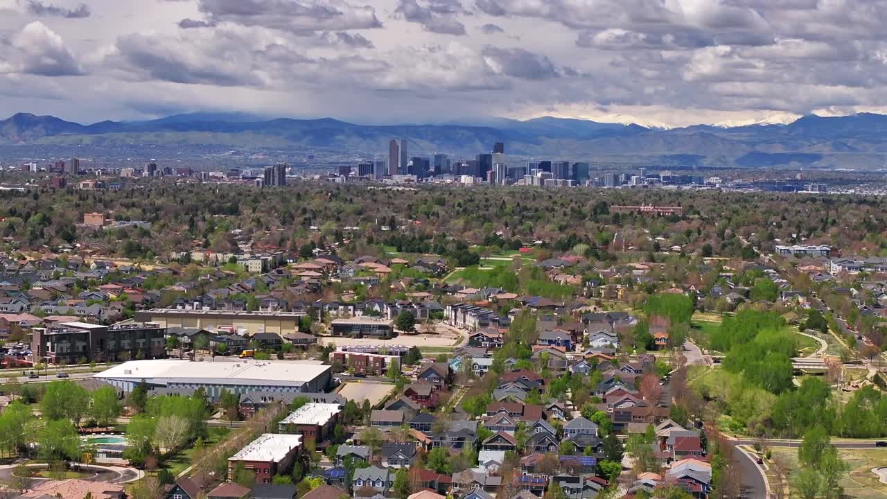 Front Range Denver Lowry Northfield Central Park neighborhood apartment buildings Colorado aerial drone sunny cloudy sky cloudy Lakewood Arvada Golden cars cityscape skyscrapers forward up motion
