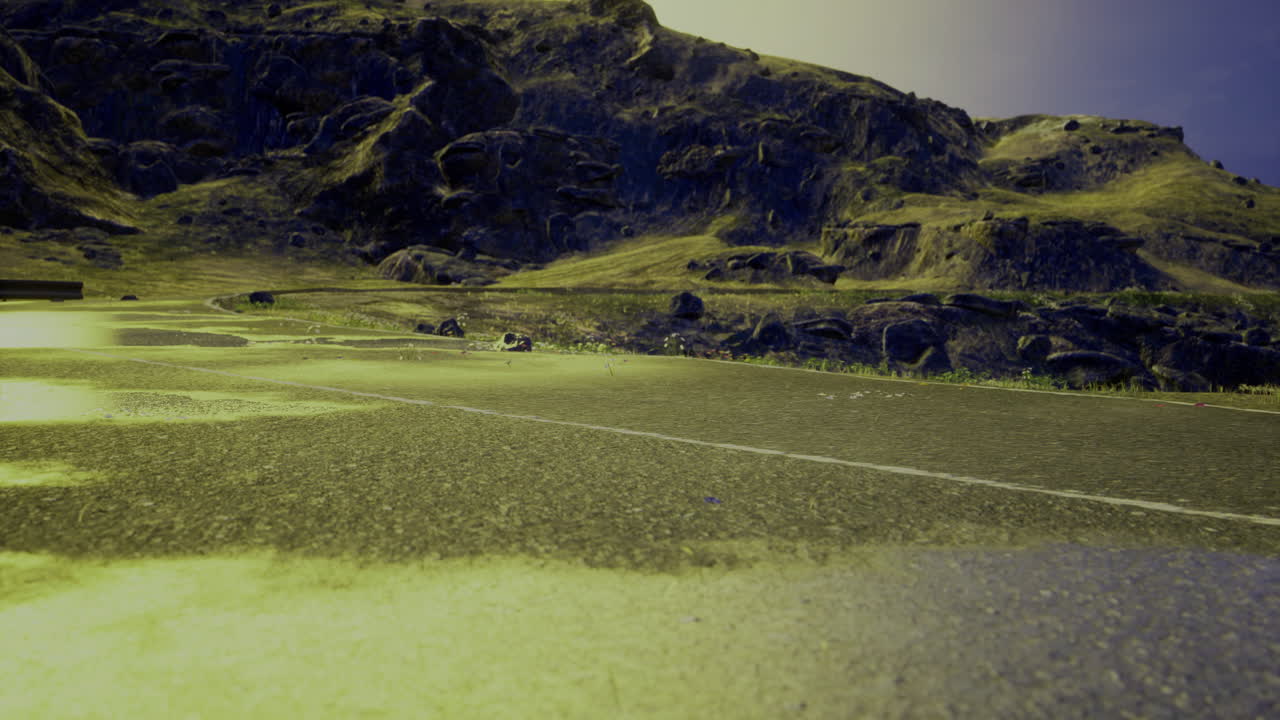Serene landscape with rocky hills and empty road under blue sky