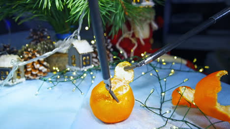 minimal invasive surgical equipment used for peeling tangerines. possibilities of delicate work of innovative surgical technologies.
