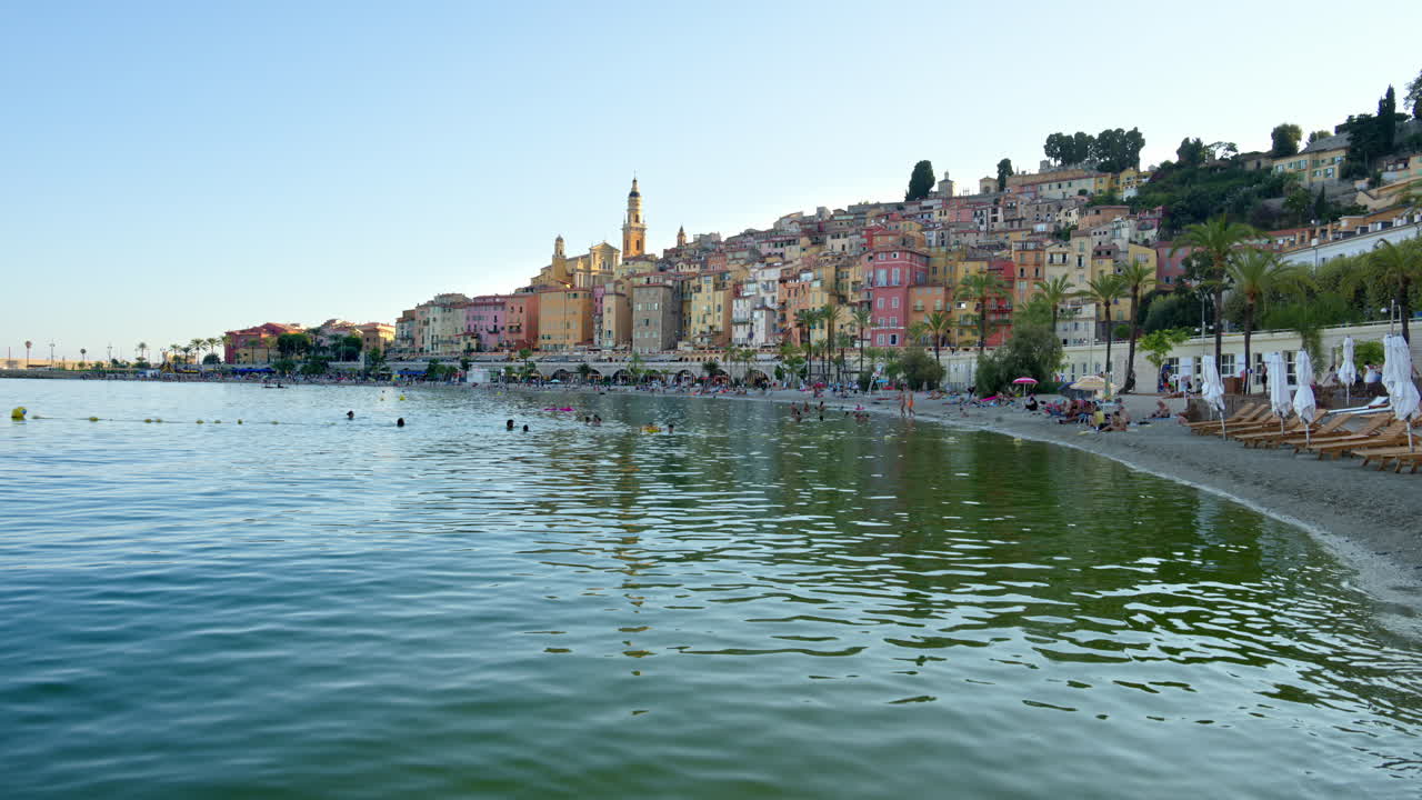 View of the sea with the colourful buildings in Menton, France on the background