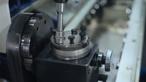 Manual-worker-assembling-machine-parts-at-production-line