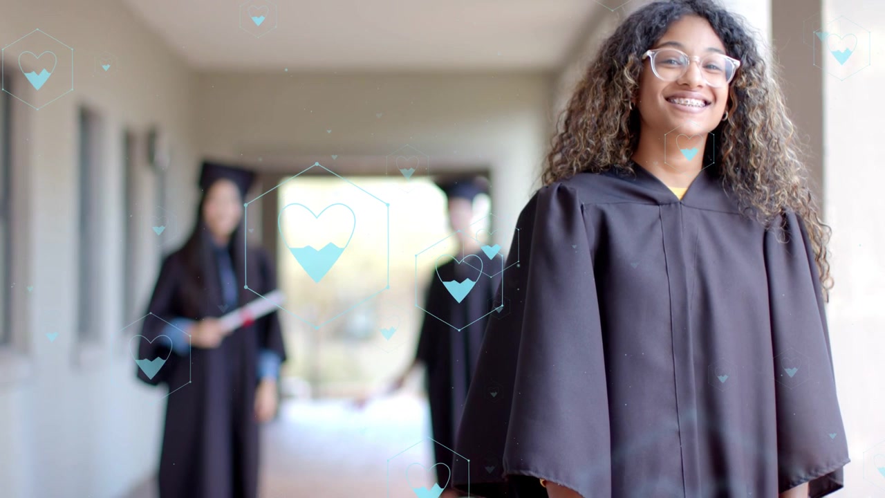 Female grad stepping forward camera tightening smiling for graduation blue hearts crossing subject