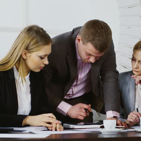 3 smartly dressed business people work with a tablet