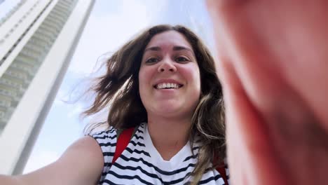 woman with striped shirt filming selfie