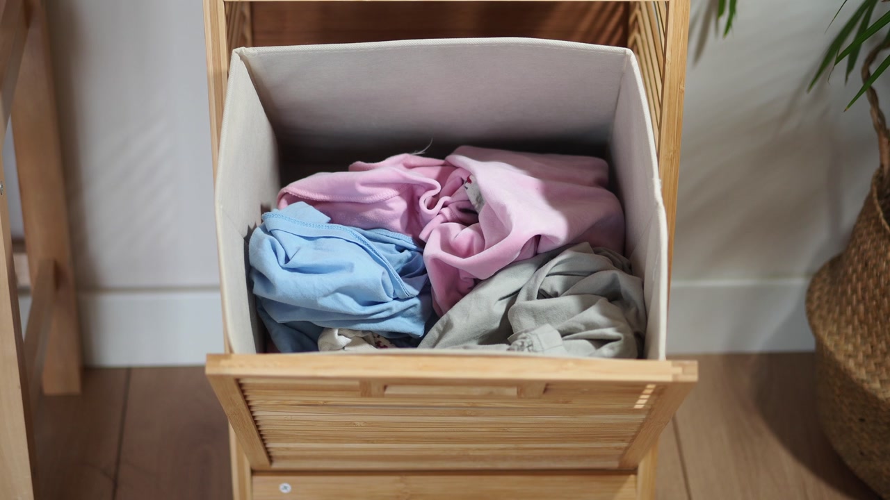 Close-up of Dirty Laundry in a Wooden Hamper