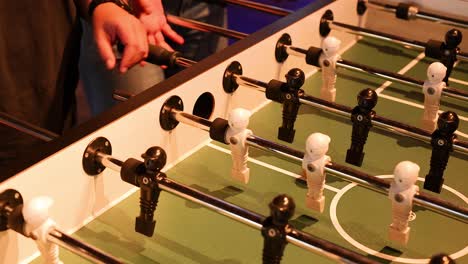 players engaged in intense foosball match