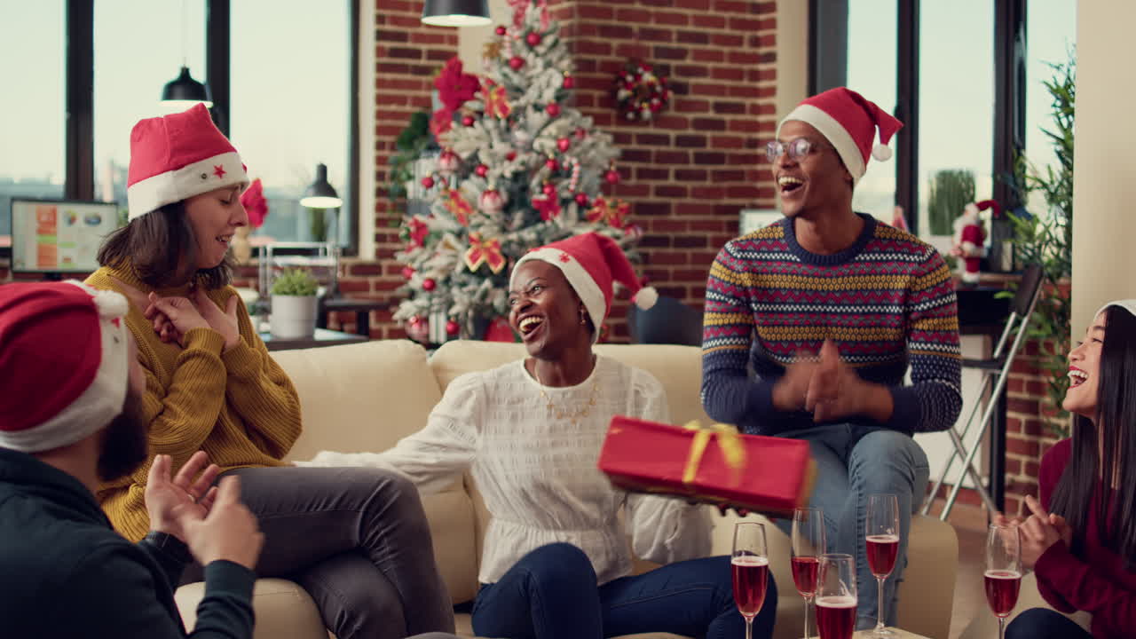 Employees giving presents on christmas eve party