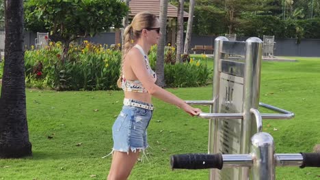 woman exercising at outdoor fitness station