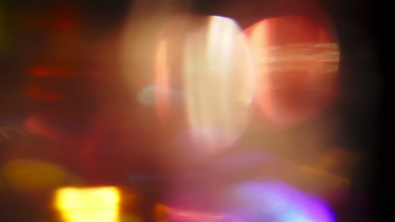 Loopable colorful background. Surrealistic light transitions. Light beams pulses on dark background