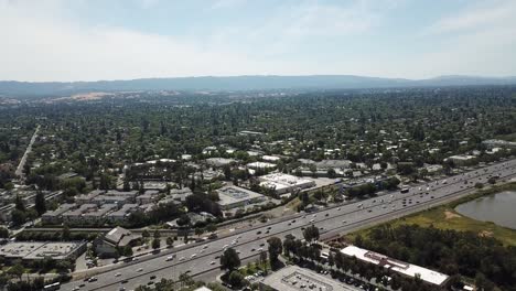 Aerial-view-of-suburbs-dense-trees-rooftop-houses-pine-trees-move-forward-and-turn-right