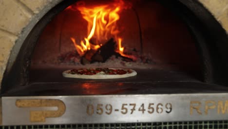 pizza baking in wood-fired oven