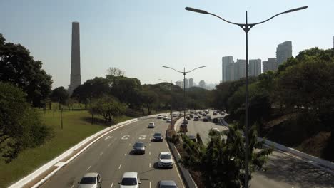 light traffic on '23 de maio avenue', important freeway of sao paulo city. monument obelisk on the back