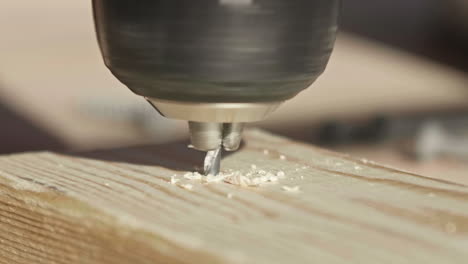 drill bit boring through lumber, close, slow motion