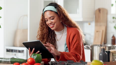 woman using tablet for cooking instructions in a kitchen