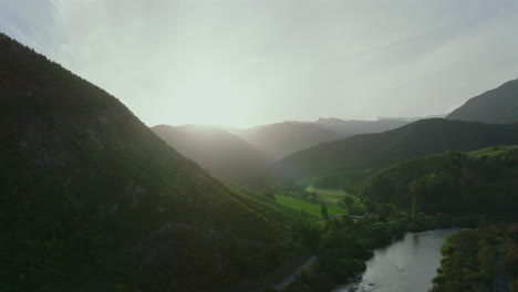 the golden hour sun set creeping over the hill at the motueka river, new zealand