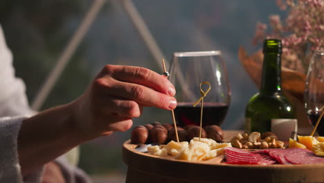 person enjoying a cheese and wine board