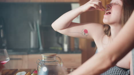 a joyful girl in a towel, looking excited as her friend drops a pizza slice in front of her during a fun meal together, the warm ambiance adds to the happy mood of the moment