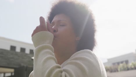 video of plus size african american woman using inhalator outdoors