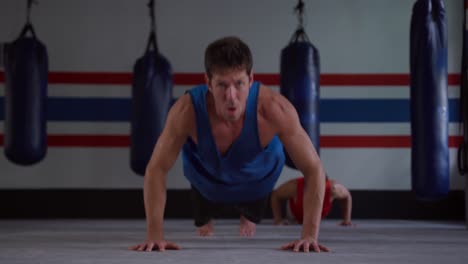 caucasian men working out in boxing gym