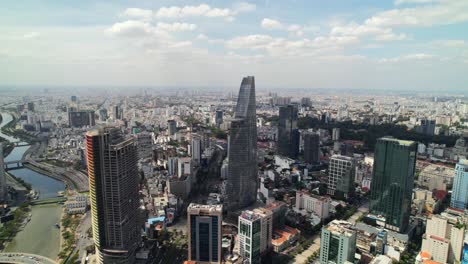 aerial zoom out of bitexco financial tower surrounded by modern skyscrapers in ho chi minh city vietnam