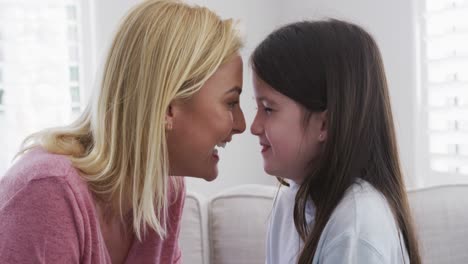 Mother-embracing-her-daughter-at-home