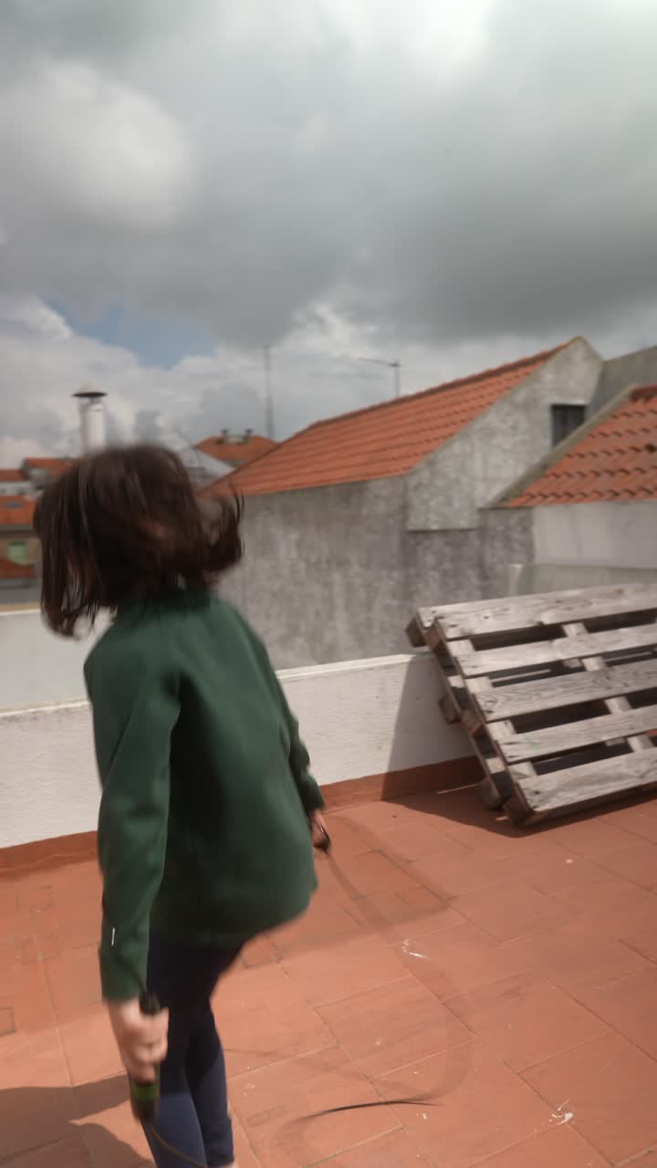 Girl Jumping Rope on Rooftop