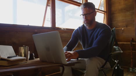 Man using laptop at home 4k