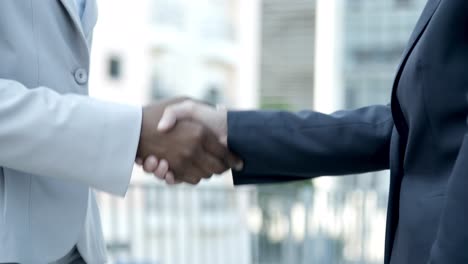 slow motion shot of people shaking hands outdoor