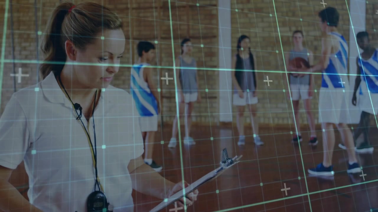 Coach timing basketball dribbling and noting times on clipboard stopwatch in gym signalling player