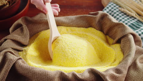 pouring cornmeal into a sack