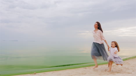 Carefree-Mother-And-Daughter-Three-Years-Running-By-The-Beach