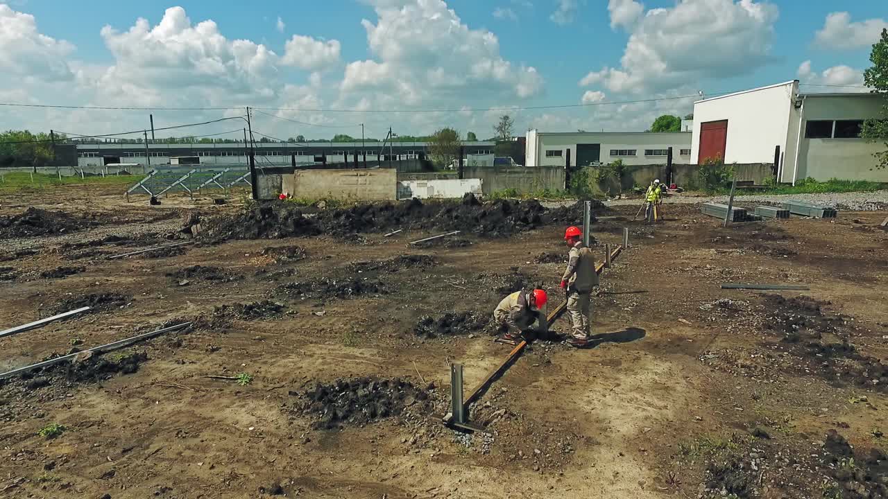 Workers on construction site. Construction workers collaborating in the installation of frames