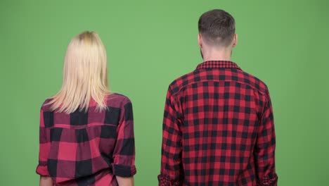 Young couple turning around and smiling after together