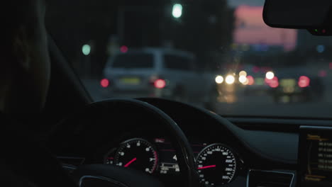 man driving car at sunset