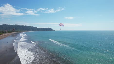 aerial images of the beach on a sunny day, following water parachute, aerial drone images, beach jaco, puntarenas, costa rica, dolly inn, tracing