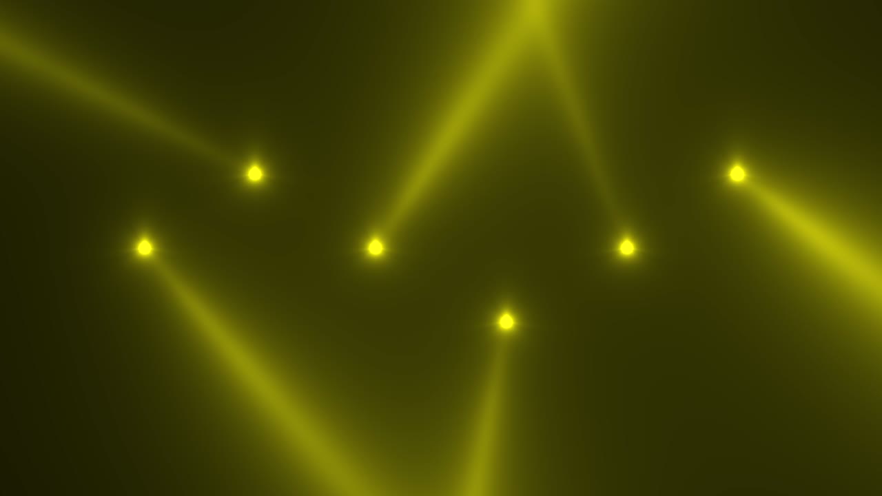 Glowing yellow spotlight beams on stage