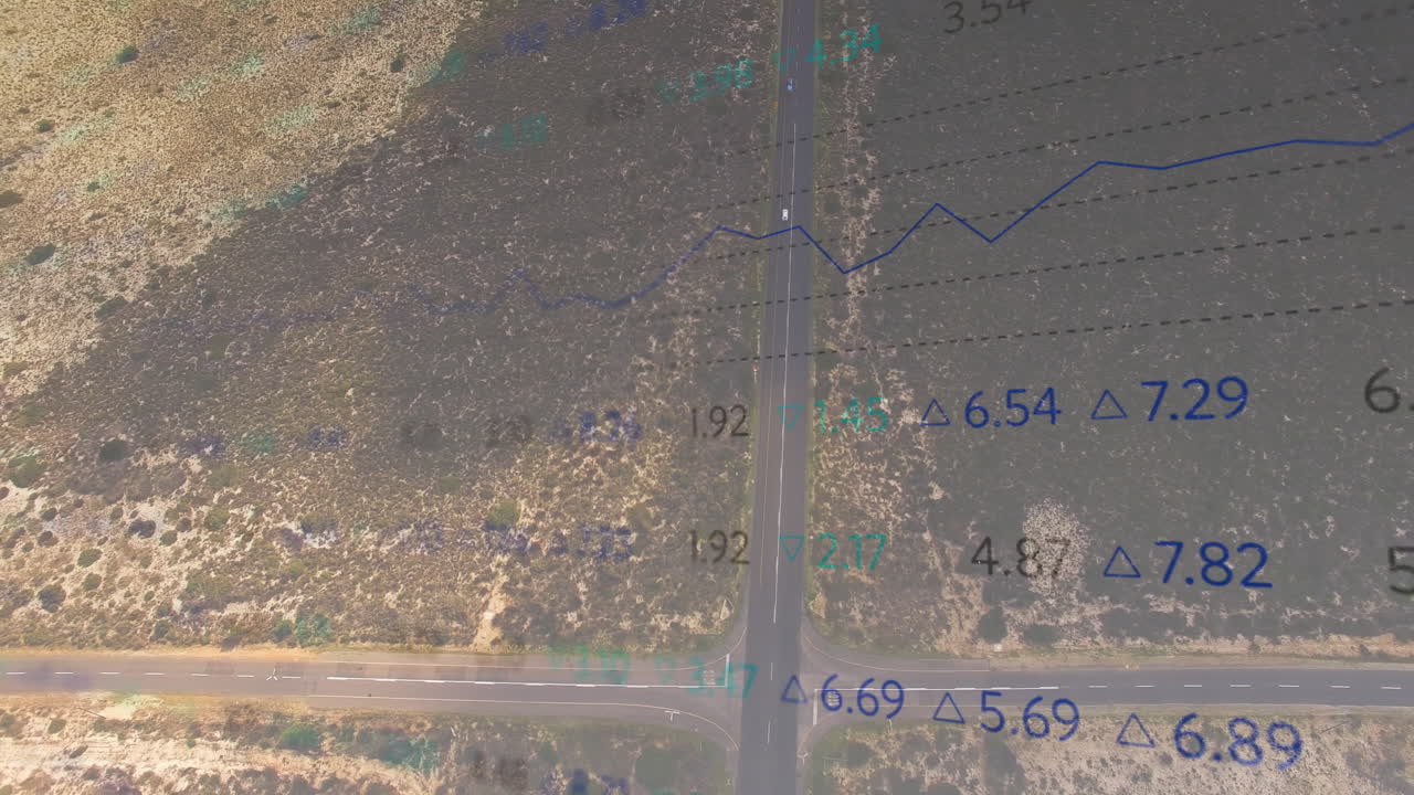 Displaying aerial T?intersection road network cutting arid scrubland with data grid overlays